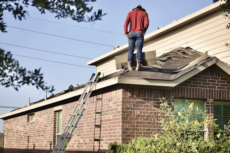 Professional roofer working on a residential roof in Deco